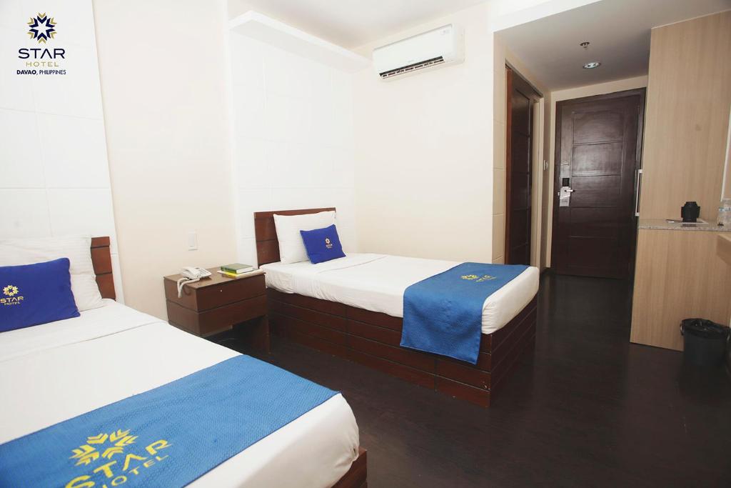 Postel nebo postele na pokoji v ubytování Star Hotel