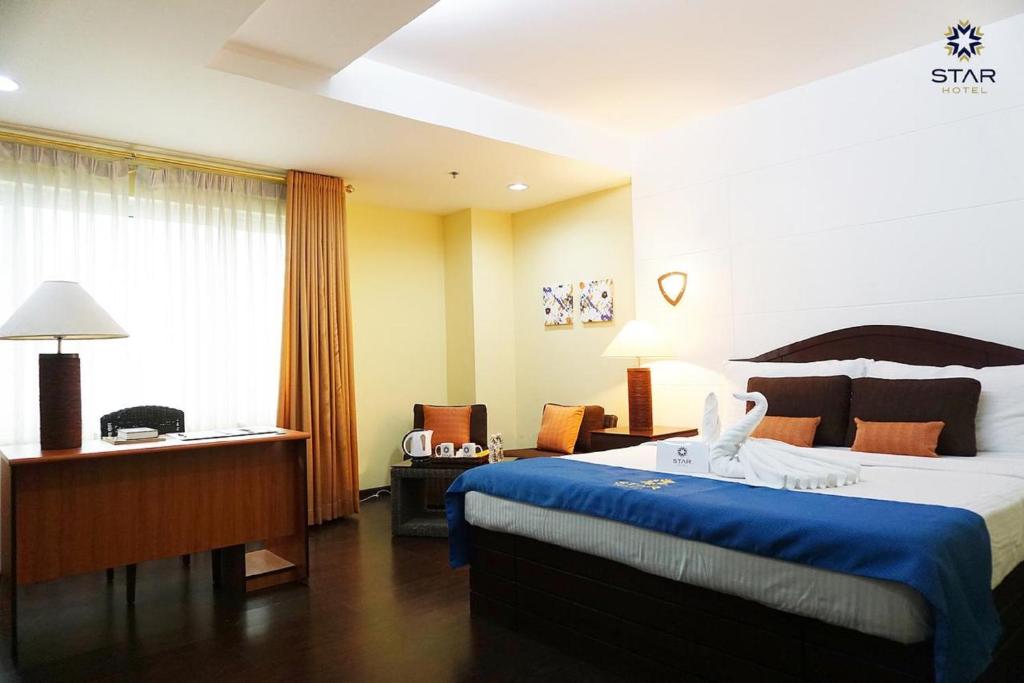 Postel nebo postele na pokoji v ubytování Star Hotel