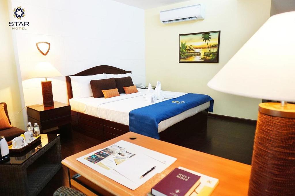Postel nebo postele na pokoji v ubytování Star Hotel