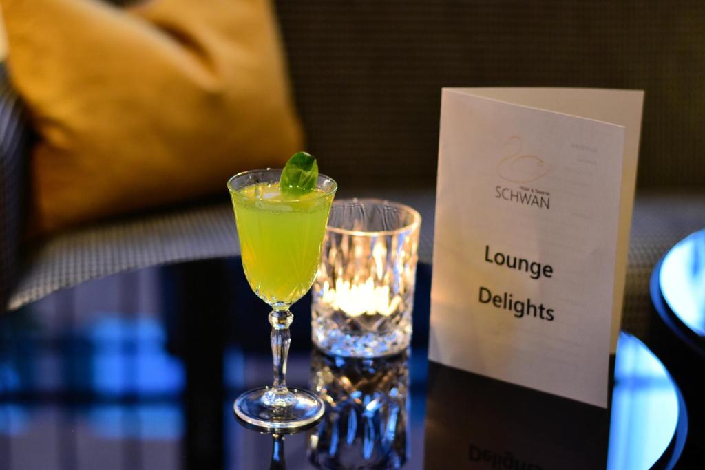 a drink in a glass sitting on a table at Romantik Hotel Schwan in Horgen