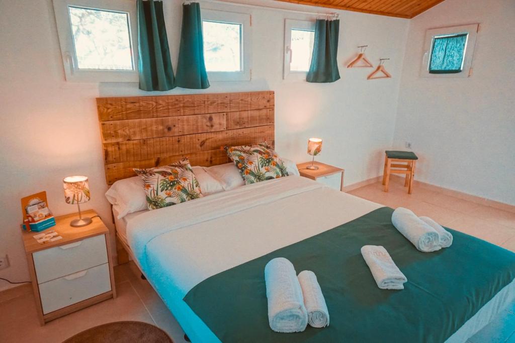 a bedroom with a large bed with two pillows at Oasis Backpackers Hostel Sintra Surf in Sintra