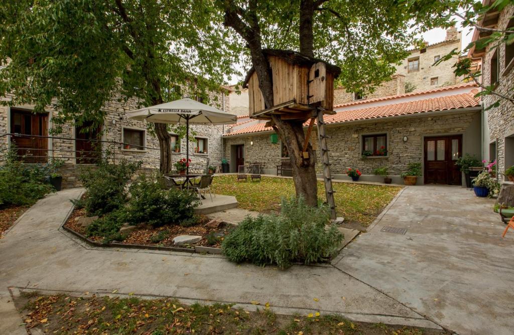 a bird house on a tree in a yard at Hotel Rural Los Cerezos de Yanguas in Yanguas