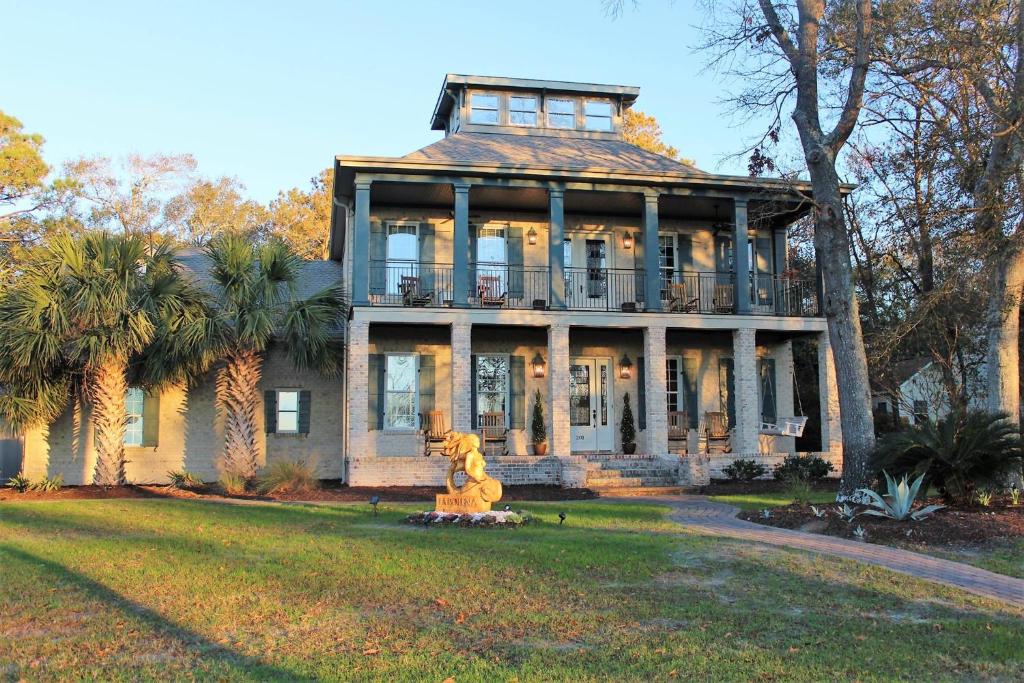 una casa grande con una estatua delante de ella en LaPolena Bed & Breakfast, en Southport