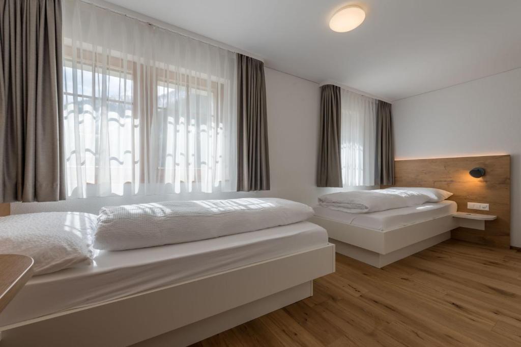 Postel nebo postele na pokoji v ubytování Hotel Walser