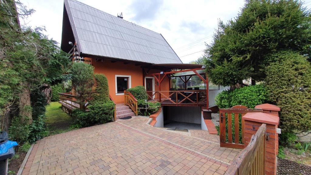 a house with a brick walkway in front of it at Domek Eve in Giżycko