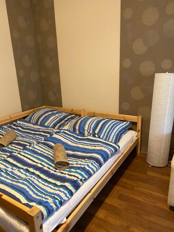 A bed or beds in a room at Virág Vendégház