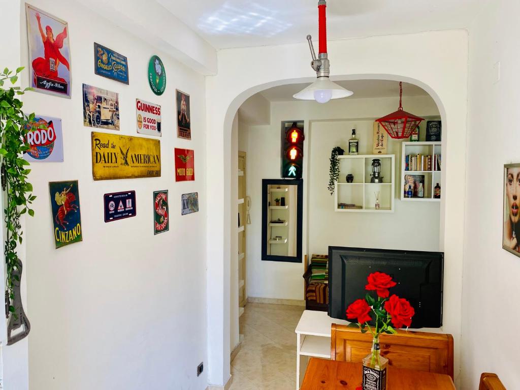 a living room with a tv and posters on the wall at Vatican Town House in Rome