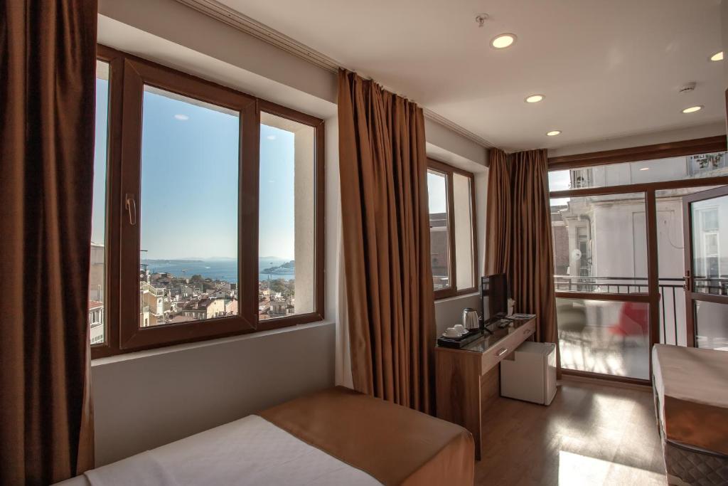 a hotel room with a bed and large windows at West Palace in Istanbul