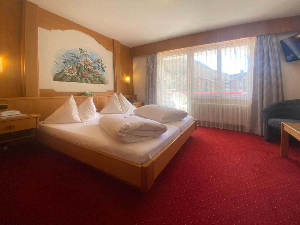 Ein Bett oder Betten in einem Zimmer der Unterkunft Hotel Restaurant Mattmarkblick