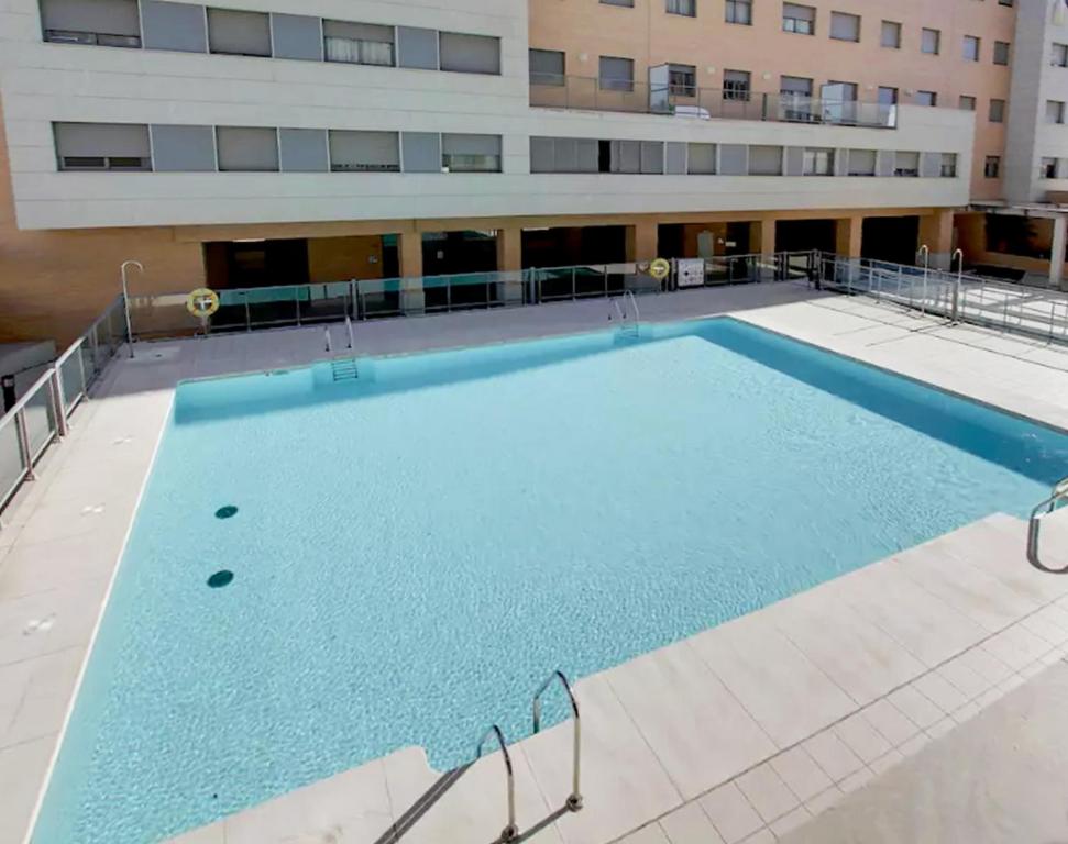 a large swimming pool in front of a building at MalagadeVacaciones - Pacifico 18 in Málaga