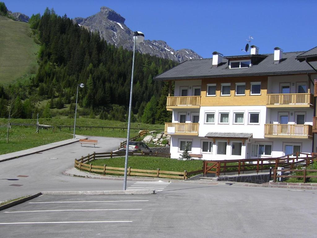 a parking lot in front of a large building at Alpenroyal Arabba in Arabba