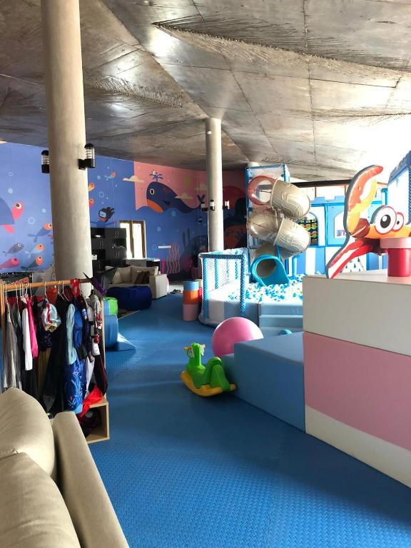 a childrens room with a blue carpeted floor and a play area at Cinnamon Bentota Beach - Signature Selection in Bentota