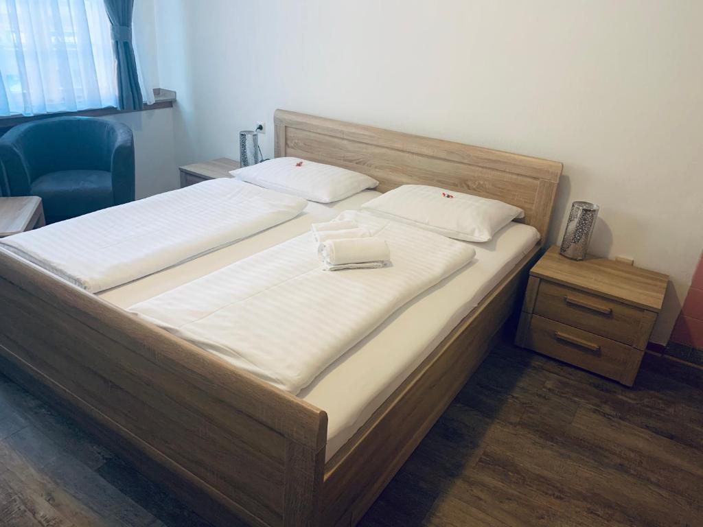 a bed with two white pillows on top of it at Hotel Brauhaus zur Krone in Bergheim