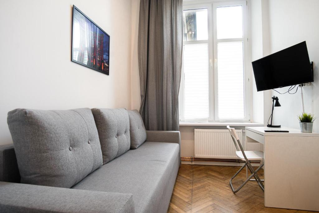 Televízia a/alebo spoločenská miestnosť v ubytovaní Dream Aparts - Rewolucji