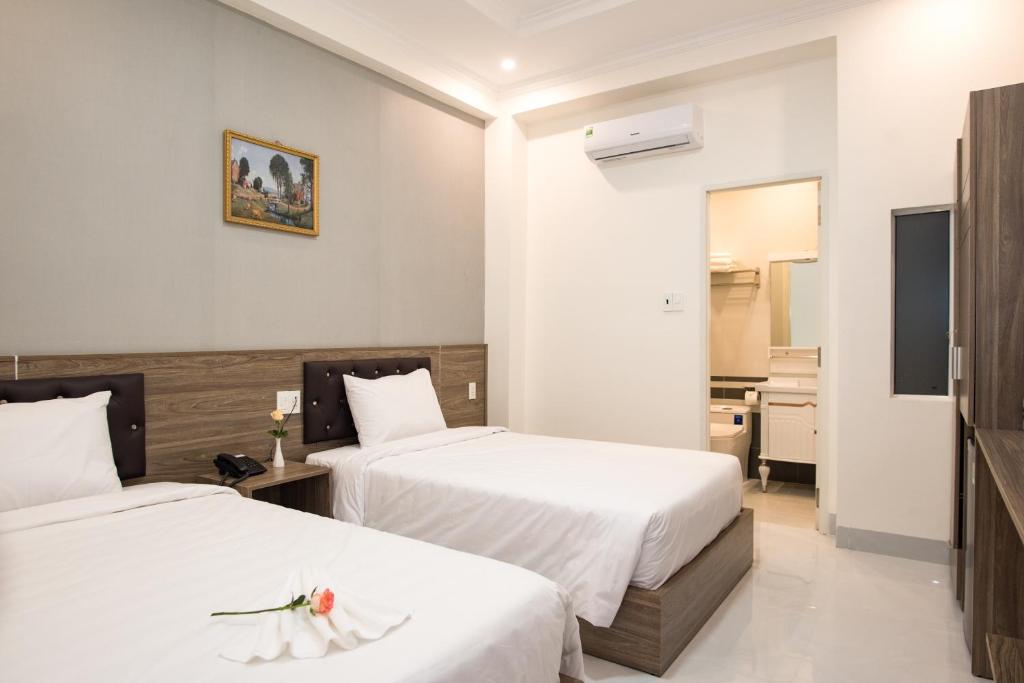 Postel nebo postele na pokoji v ubytování Amora Hotel & Apartment