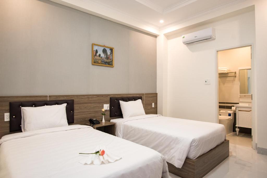 Postel nebo postele na pokoji v ubytování Amora Hotel & Apartment