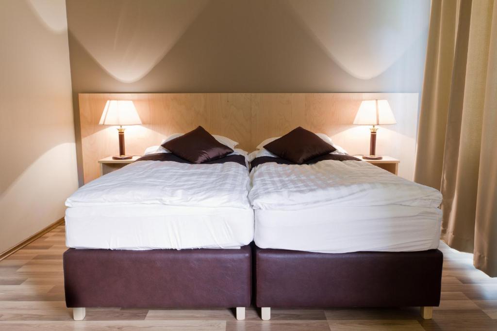two beds sitting next to each other in a bedroom at Hotel Hallormsstadur in Hallormsstaður