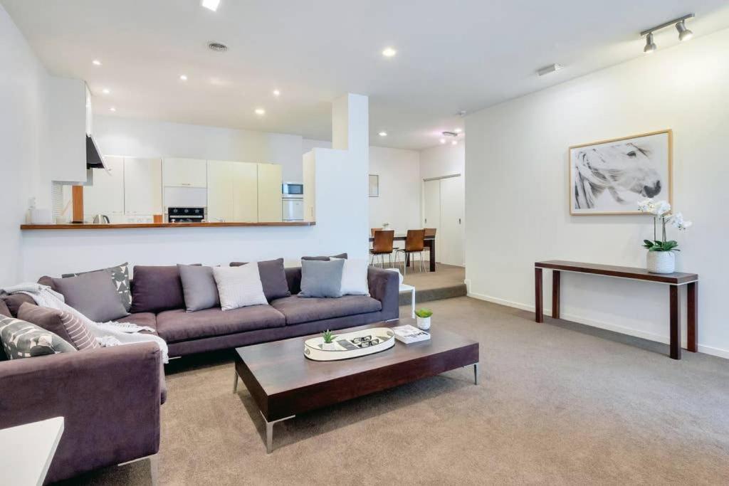 a living room with a couch and a table at Spacious 2BR Near Westfield Newmarket in Auckland
