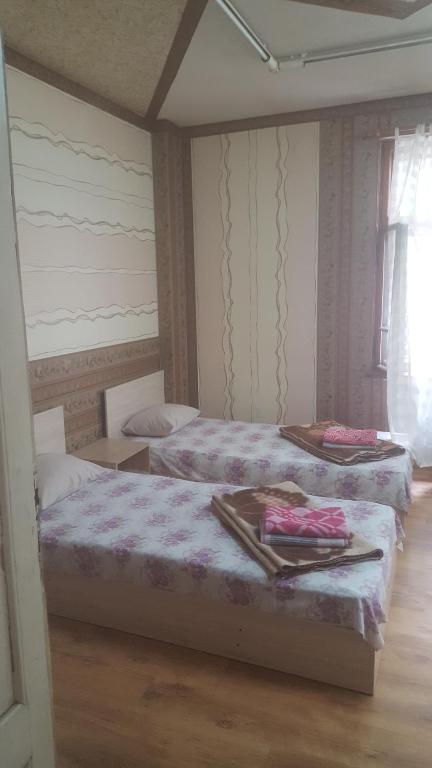 a bedroom with two beds and a window at Hostel Alex 1 in Sofia
