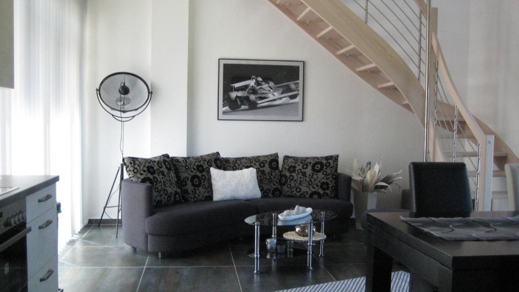 a living room with a couch and a staircase at FeWo Marita in Wimbach