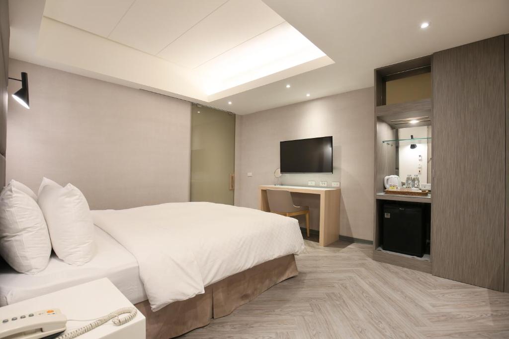 Postel nebo postele na pokoji v ubytování Dandy Hotel-Daan Park Branch