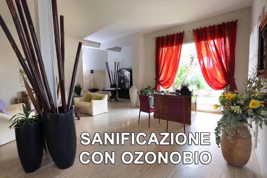 a living room with red curtains and a table and chairs at La Vigna in Leverano