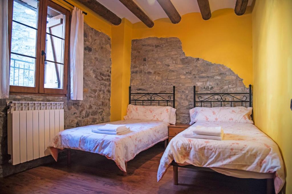Postel nebo postele na pokoji v ubytování Casa Pirinea Ordesa