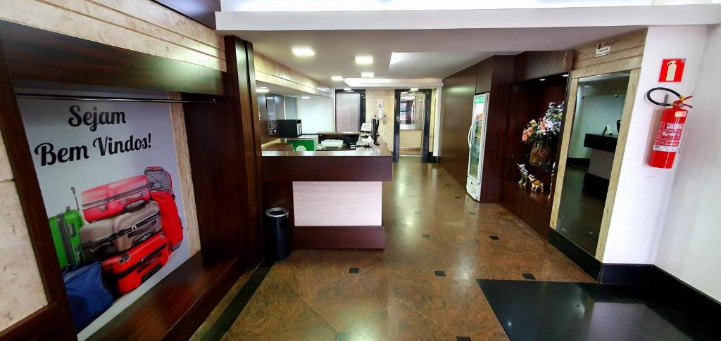 a hallway of a store with a sign on the wall at Center Patos Hotel in Patos de Minas