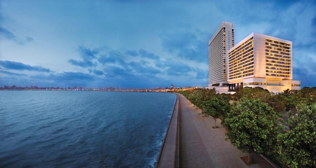 a large building with a view of the ocean at The Oberoi Mumbai in Mumbai