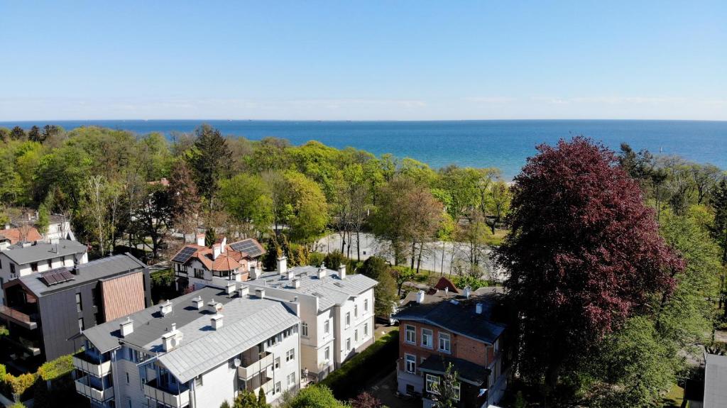 an aerial view of a town with houses and the ocean at VIU Seaside Residence in Sopot