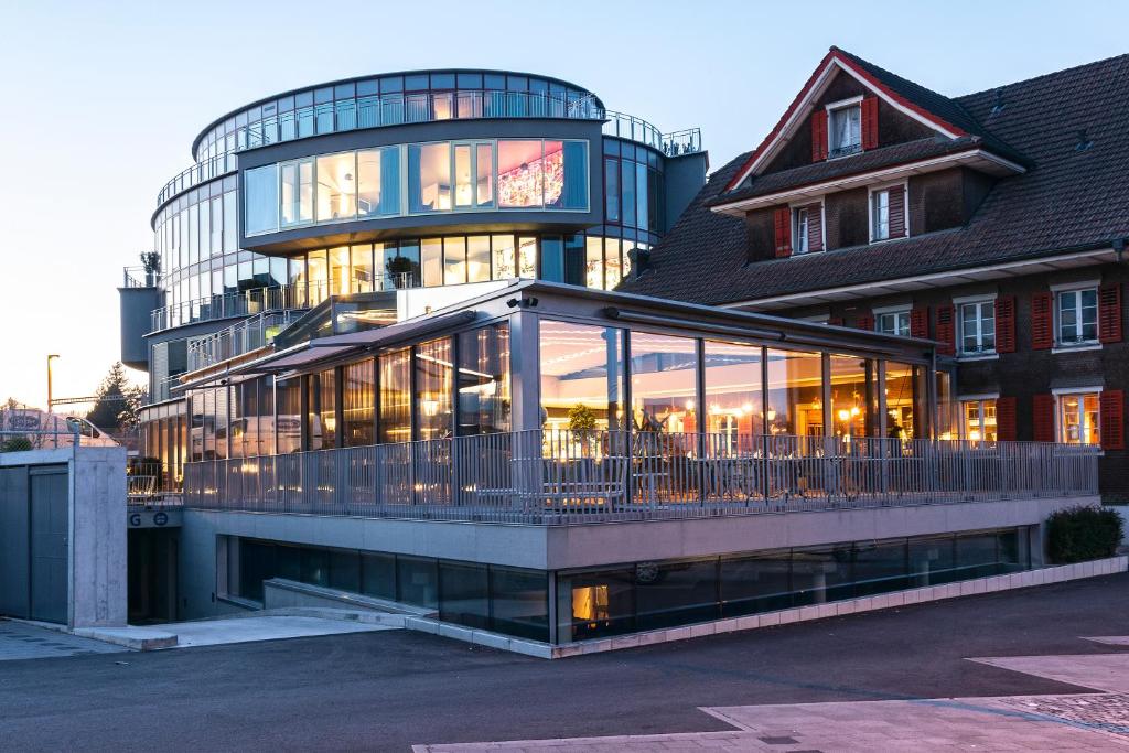 a building with a lot of glass in front of it at HIRSCHEN OBERKIRCH - Design Boutique Hotel in Oberkirch