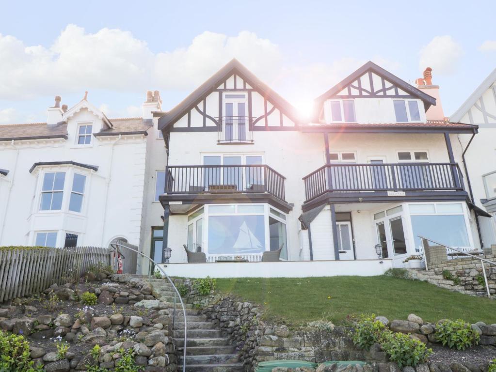 a large white house with a garden in front of it at Flat 3, Peacehaven in Whitby