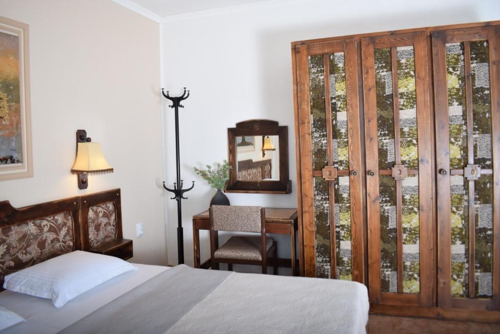 A bed or beds in a room at Family Hotel Apolonia