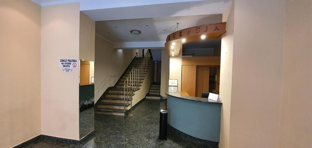 a hallway with a staircase in a building at Hostel Ratuszowy in Bydgoszcz