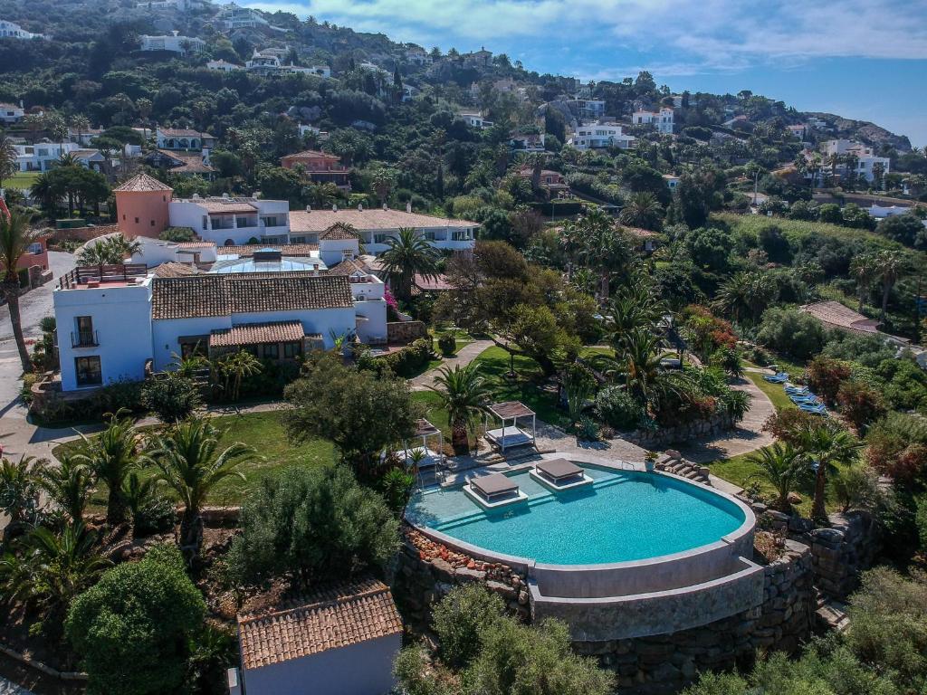 an aerial view of a villa with a swimming pool at El Cortijo de Zahara by QHotels in Zahara de los Atunes