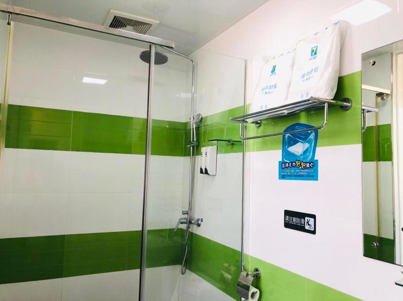 a shower in a bathroom with green and white stripes at 7Days Inn Sihui Middle Avenue in Zhaoqing