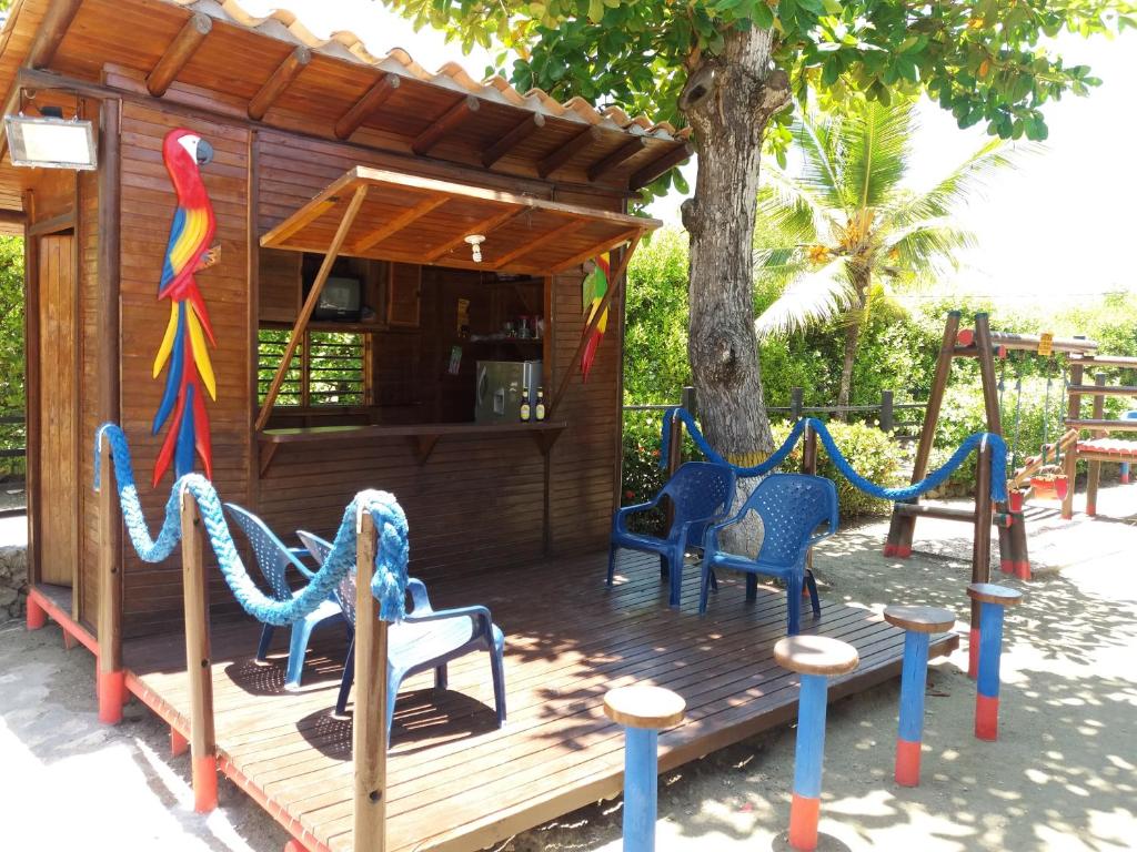 a playground with chairs and a play house at Cabanas Recreaciones in Coveñas