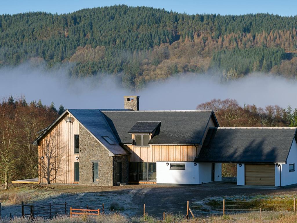 a barn with fog in the background at Sobrachan in Braevallich