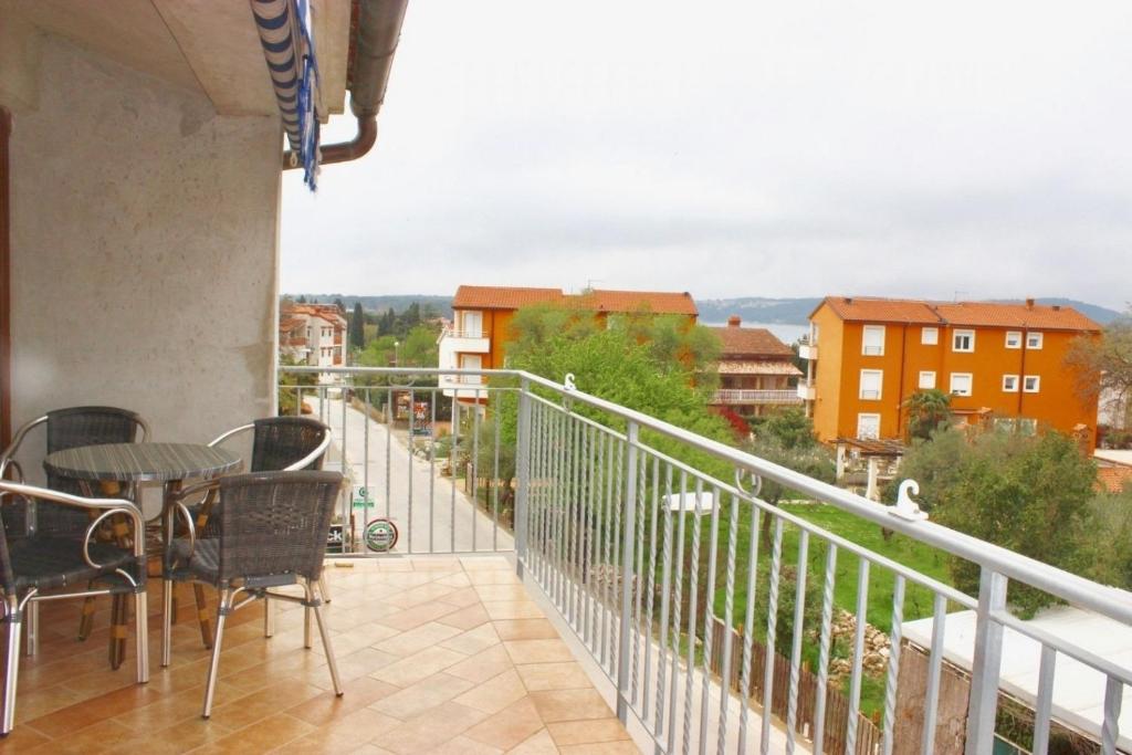 a balcony with a table and chairs and a view at Apartment Marina in Medulin