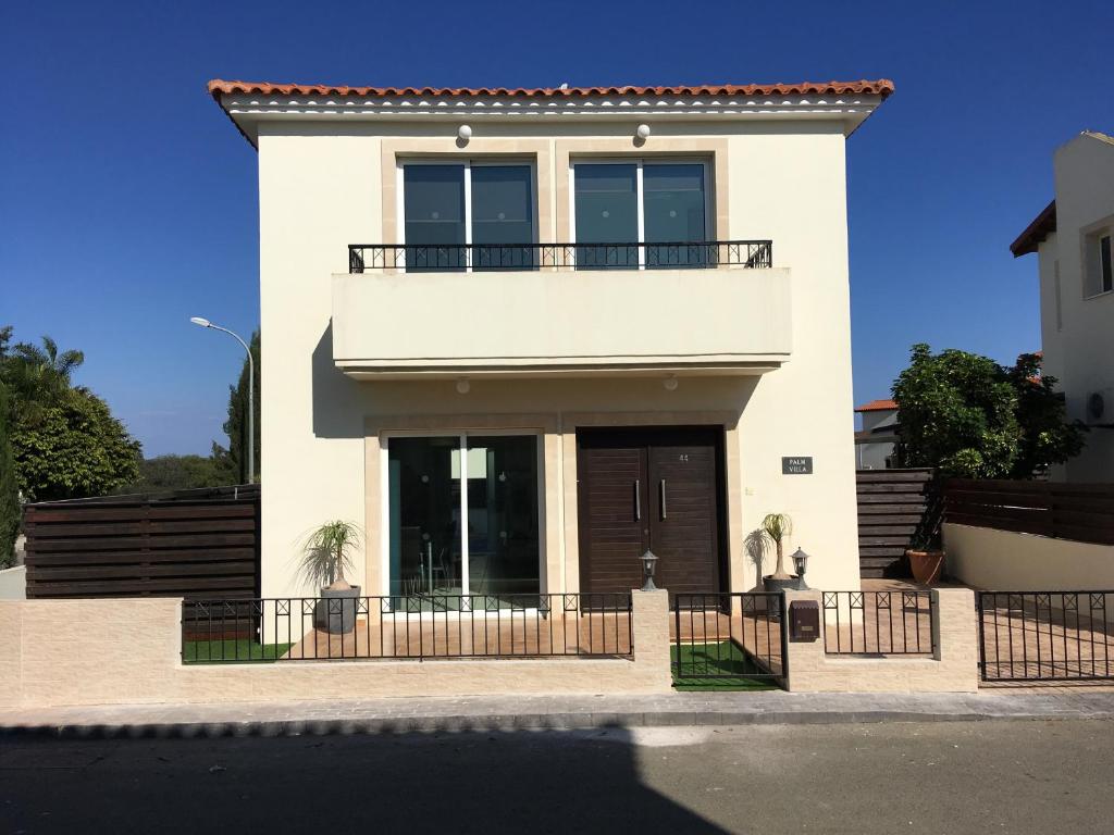 a white house with a balcony on top of it at Luxury Villa Private Pool and Wifi Perfect location for a holiday in Protaras