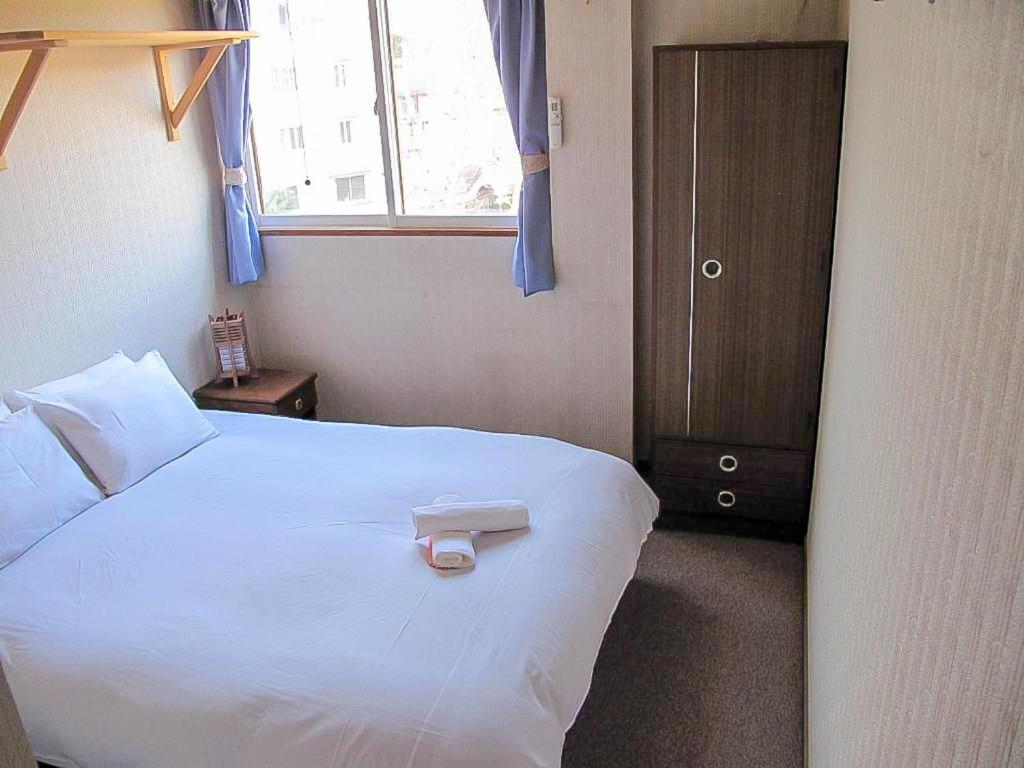 Postel nebo postele na pokoji v ubytování Asuka Lodge