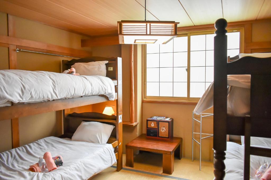 Postel nebo postele na pokoji v ubytování Asuka Lodge