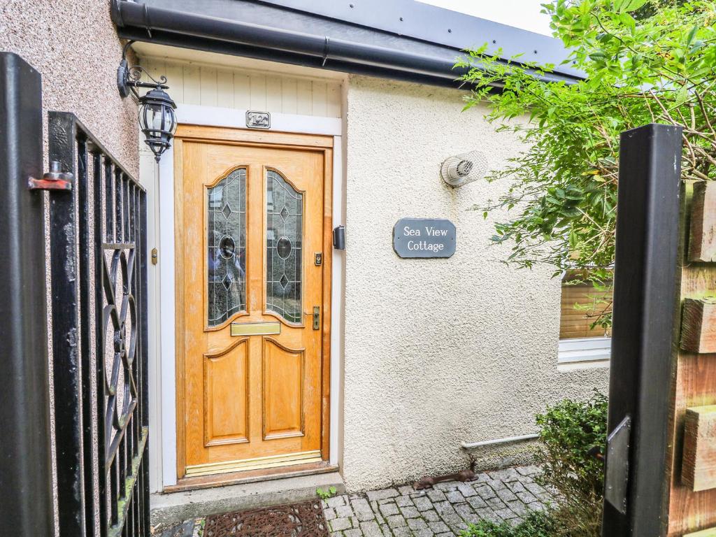 a wooden door of a house with a sign on it at Seaview in Nairn