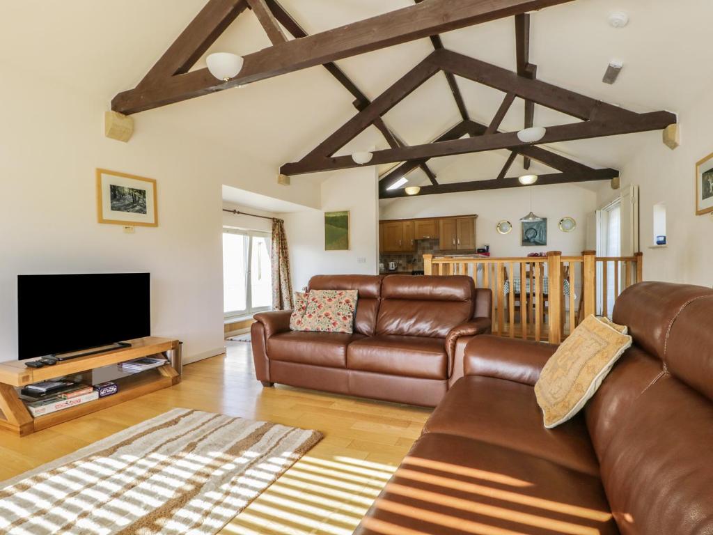 a living room with a couch and a tv at Skiddaw in Cockermouth