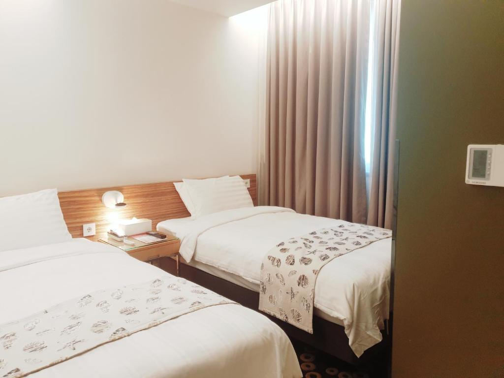 Postel nebo postele na pokoji v ubytování Hotel Matthieu Yeosu