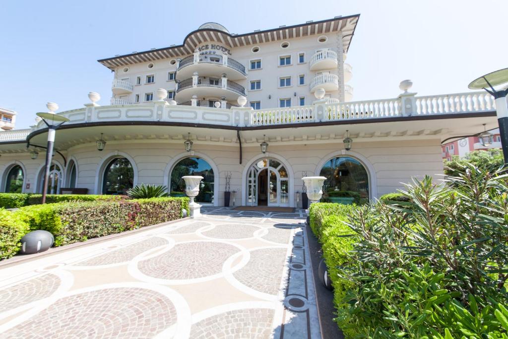 a large building with a walkway in front of it at Palace Hotel in Milano Marittima
