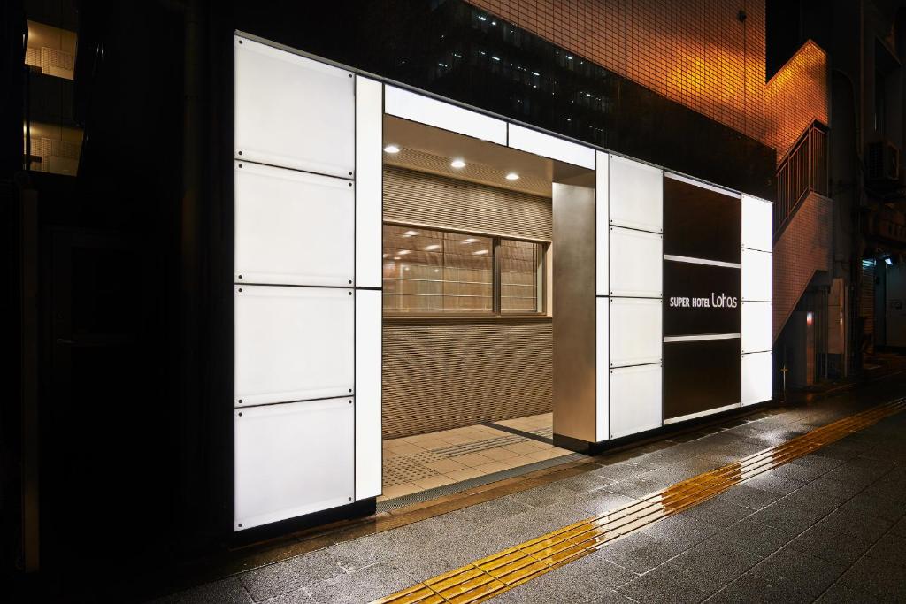 a store front with its doors open on a street at Super Hotel JR Ueno Iriyaguchi in Tokyo