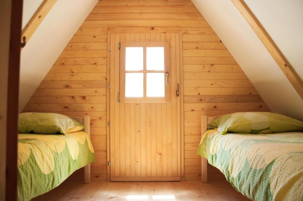 Postel nebo postele na pokoji v ubytování Cottages Kravanja