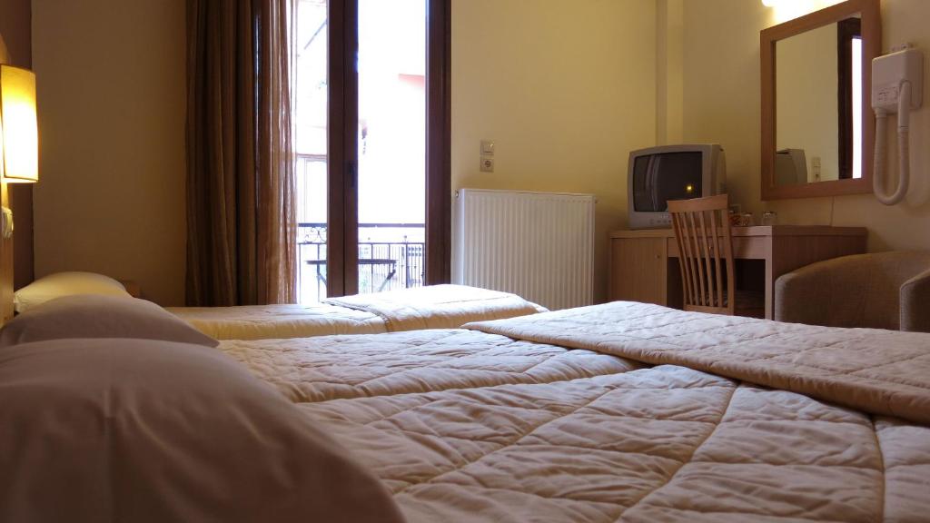 Postel nebo postele na pokoji v ubytování Hotel Leto Delphi