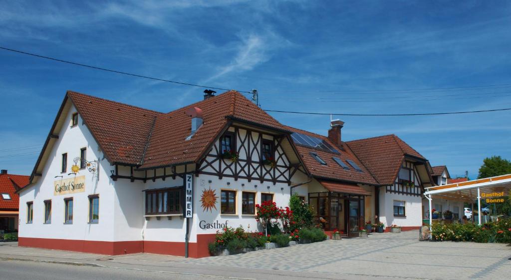 a building with a brown roof on a street at Gasthof zur Sonne in Röfingen
